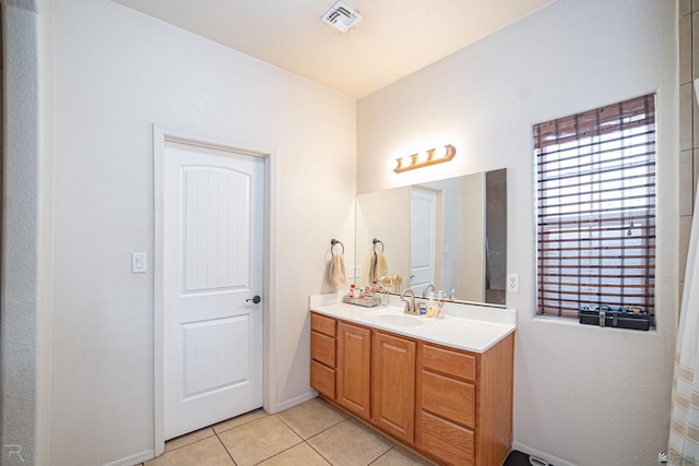 bathroom with tile patterned flooring and vanity