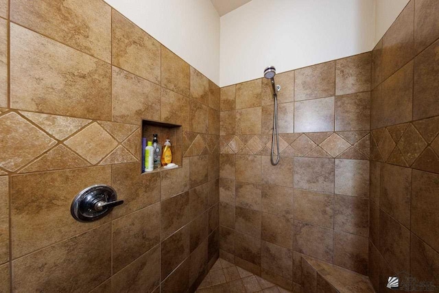 bathroom with a tile shower