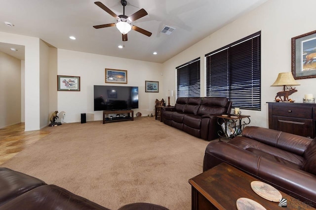 living room featuring light colored carpet and ceiling fan