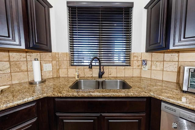 kitchen with tasteful backsplash, stainless steel dishwasher, sink, and dark brown cabinets