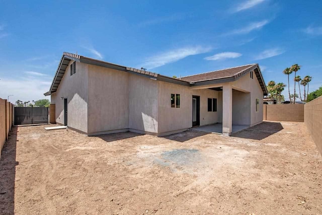 rear view of property featuring a patio