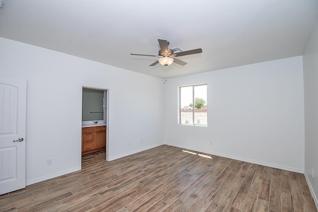 unfurnished bedroom with ceiling fan and light wood-type flooring