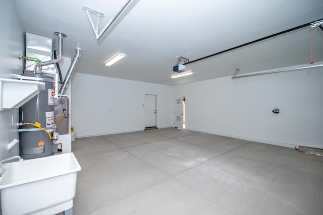 garage with strapped water heater, sink, and a garage door opener