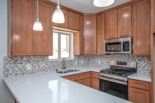 kitchen featuring pendant lighting, decorative backsplash, sink, and appliances with stainless steel finishes