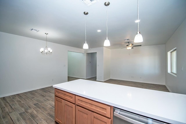 kitchen featuring stainless steel dishwasher, ceiling fan with notable chandelier, hanging light fixtures, and dark wood-type flooring