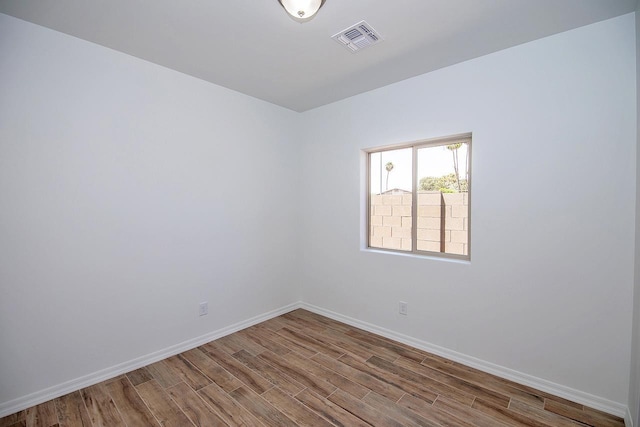 empty room featuring hardwood / wood-style flooring