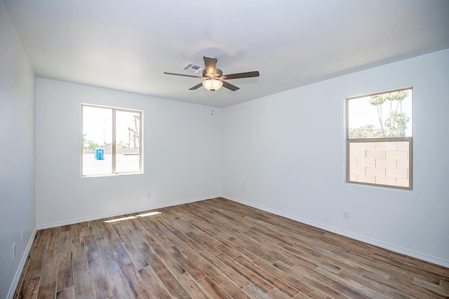 unfurnished room with hardwood / wood-style flooring and ceiling fan