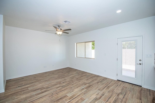 unfurnished room with ceiling fan and a wealth of natural light