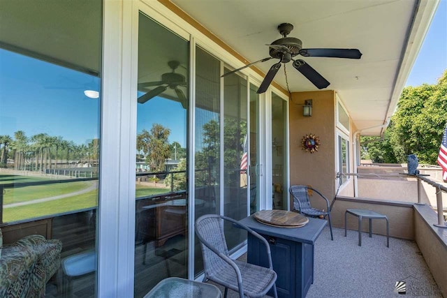 sunroom / solarium featuring ceiling fan