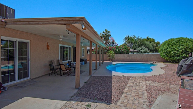 view of swimming pool featuring a fenced backyard, a diving board, a fenced in pool, and a patio