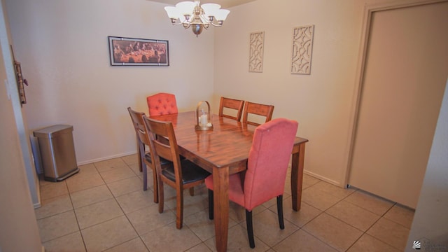 dining room featuring an inviting chandelier, light tile patterned floors, and baseboards