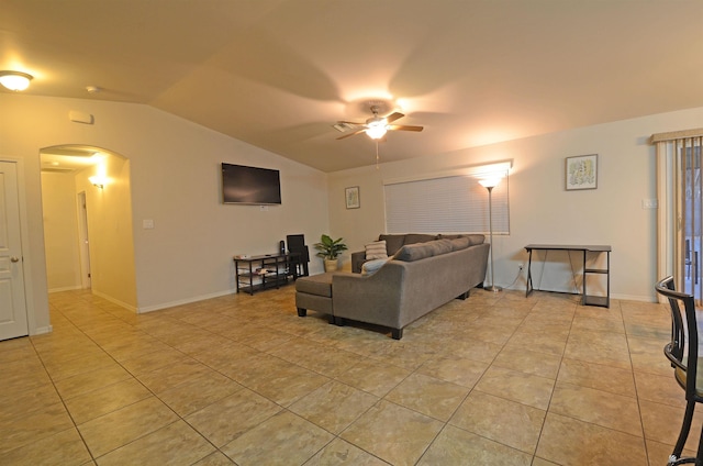 living room with light tile patterned floors, a ceiling fan, baseboards, arched walkways, and vaulted ceiling