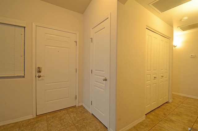 corridor with baseboards and visible vents