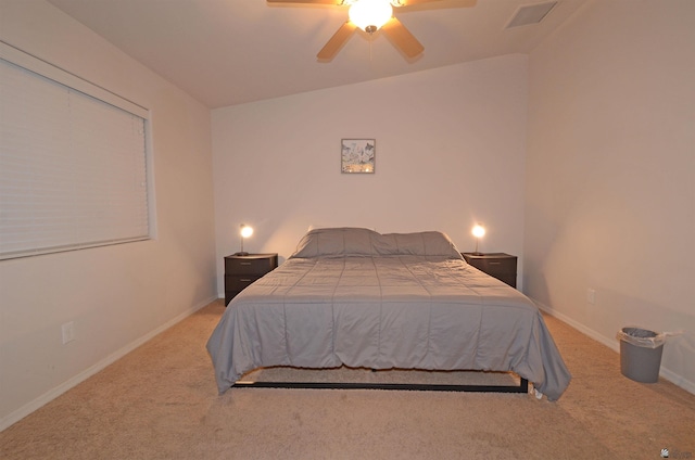 bedroom with visible vents, baseboards, ceiling fan, and carpet flooring