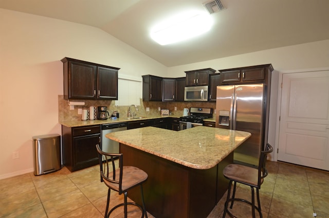 kitchen with tasteful backsplash, visible vents, lofted ceiling, appliances with stainless steel finishes, and a sink