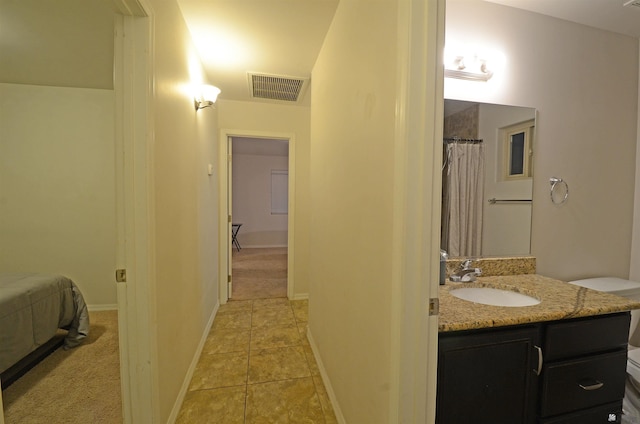 bathroom featuring tile patterned floors, visible vents, vanity, and baseboards