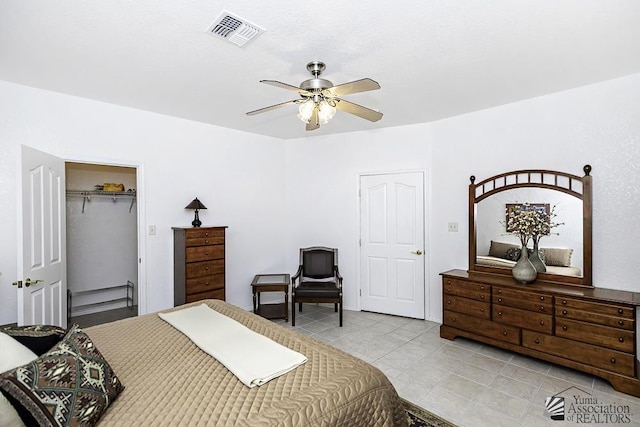 bedroom with ceiling fan and a closet