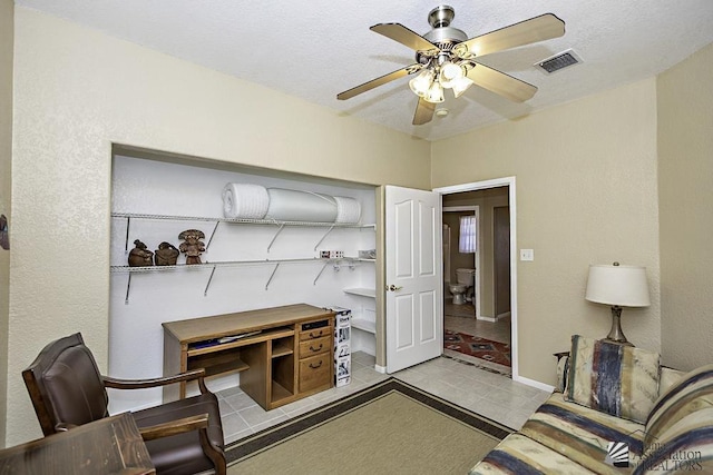 office space with ceiling fan, light tile patterned flooring, and a textured ceiling