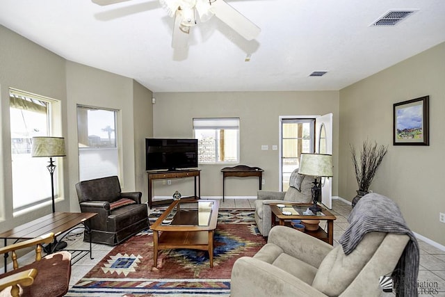 tiled living room with ceiling fan