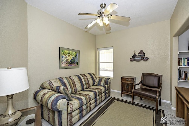 living room featuring ceiling fan and light tile patterned floors