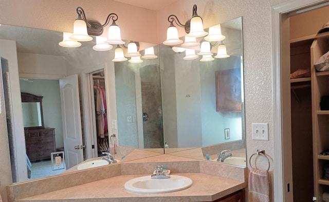 bathroom featuring a chandelier and vanity