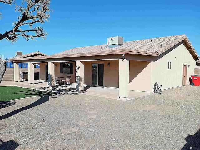 rear view of house featuring a patio area and central AC unit