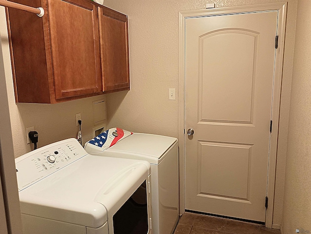 laundry area with cabinets, dark tile patterned flooring, and independent washer and dryer