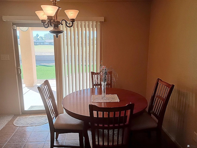 tiled dining space featuring an inviting chandelier