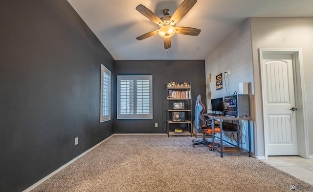 carpeted office space featuring ceiling fan