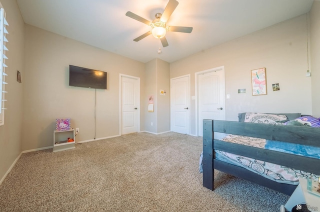 bedroom with multiple closets, carpet floors, and ceiling fan