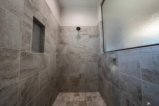 bathroom with a tile shower