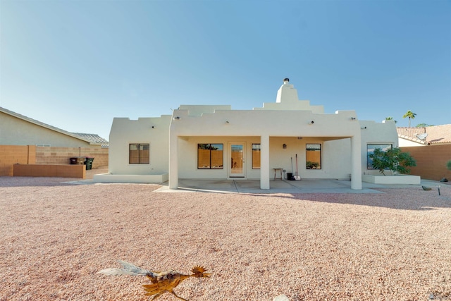 back of property with a patio area, fence, and stucco siding