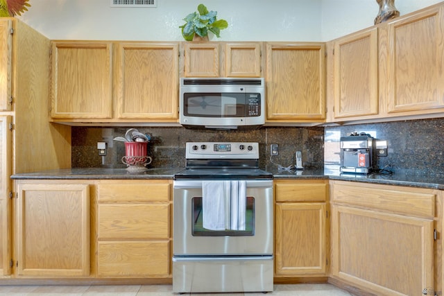 kitchen featuring visible vents, appliances with stainless steel finishes, decorative backsplash, and light brown cabinetry