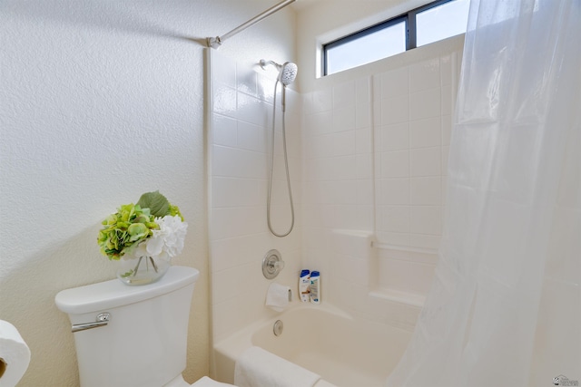 full bath with toilet, shower / bathtub combination with curtain, and a textured wall