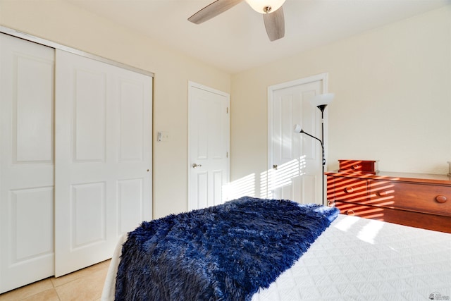 bedroom with ceiling fan, a closet, and light tile patterned flooring