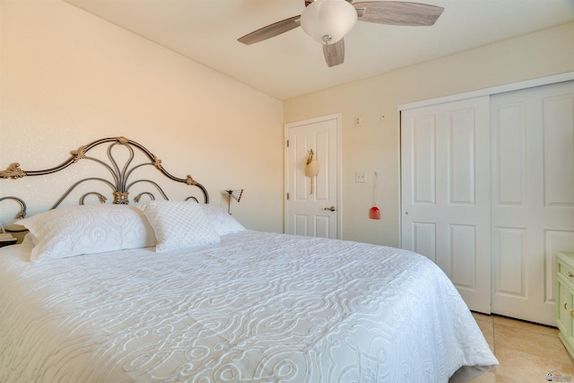 bedroom featuring light tile patterned floors, ceiling fan, and a closet