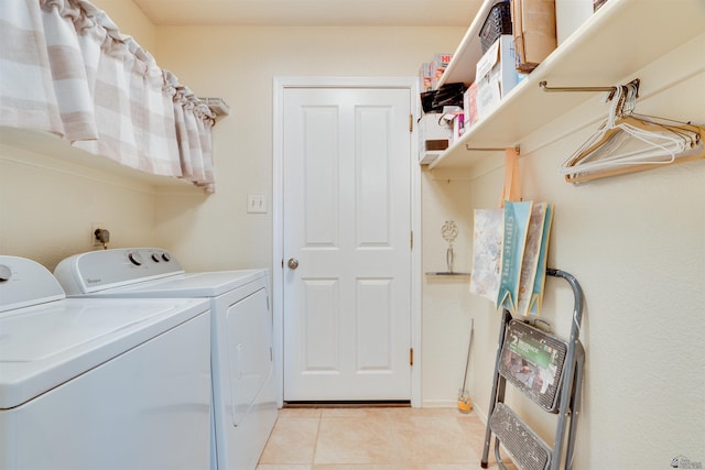 clothes washing area with laundry area, light tile patterned flooring, and washer and dryer