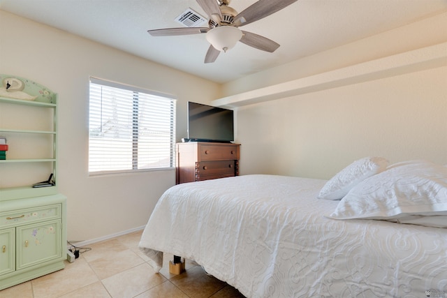 bedroom featuring light tile patterned floors, a ceiling fan, visible vents, and baseboards