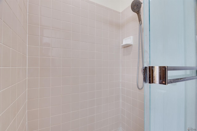 full bath with a tile shower