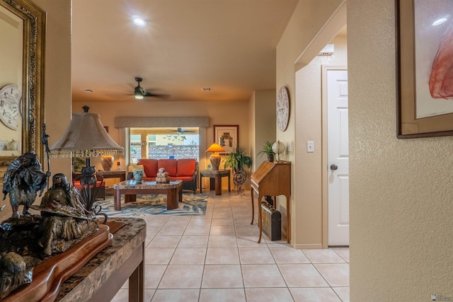 tiled living room with ceiling fan