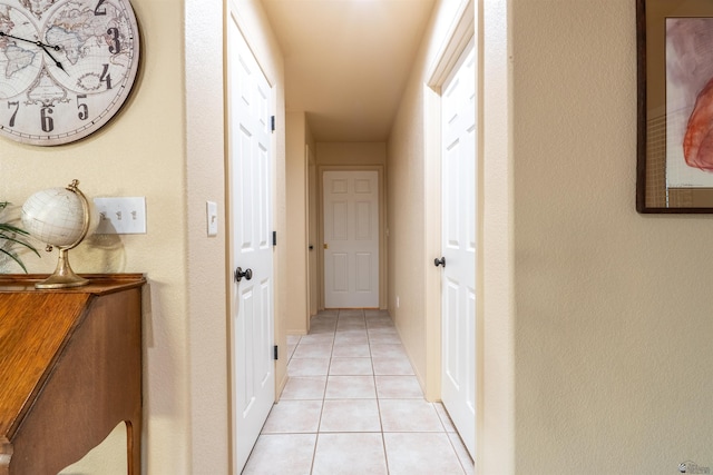 corridor featuring light tile patterned floors