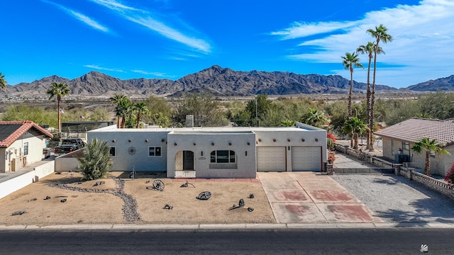 view of front of house with a mountain view and a garage