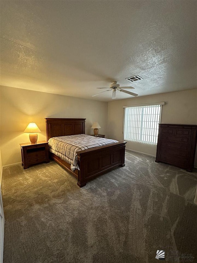 carpeted bedroom with ceiling fan and a textured ceiling