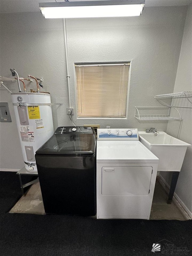 clothes washing area featuring washing machine and dryer and water heater