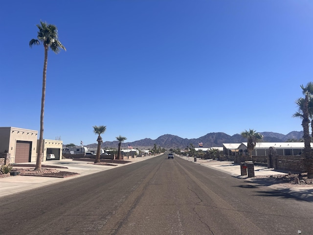 view of road featuring a mountain view and sidewalks