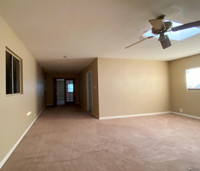 spare room with ceiling fan and light colored carpet