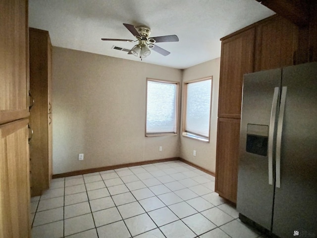 kitchen with ceiling fan, stainless steel fridge with ice dispenser, and light tile patterned floors