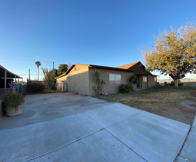 view of side of property with a yard