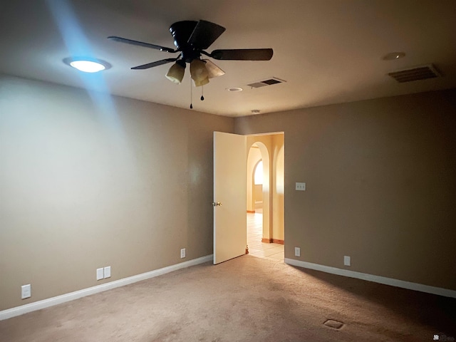 carpeted spare room with ceiling fan