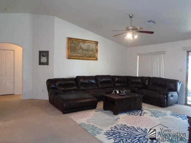 living room with carpet flooring, a wealth of natural light, ceiling fan, and vaulted ceiling